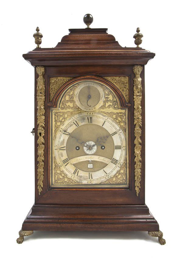 An English Gilt Metal Mounted Walnut and Brass Bra: An English Gilt Metal Mounted Walnut and Brass Bracket Clock, John Taylor, London, having a spherical finial over the sarcophagus top with urn form finials at each corner above the rectangular case se