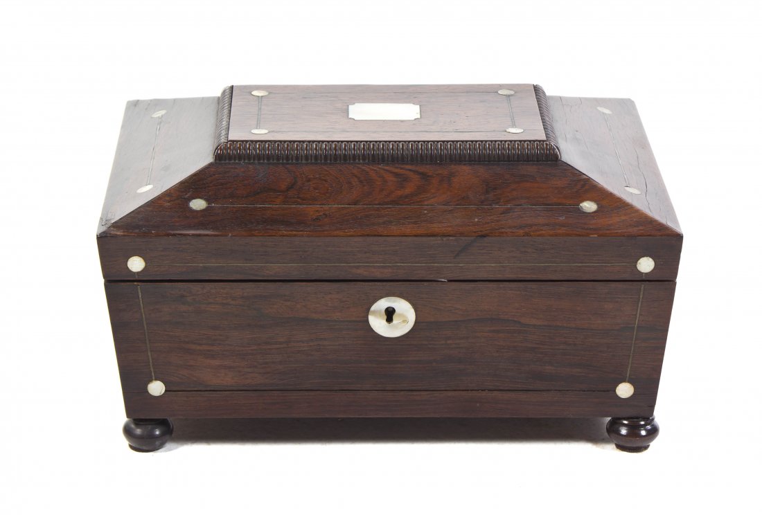 A Regency Rosewood and Mother-of-Pearl Inlaid Sewi: A Regency Rosewood and Mother-of-Pearl Inlaid Sewing Box, having a hinged lid over the conforming case opening to a fitted interior, raised on bun feet. Width 12 1/4 inches.