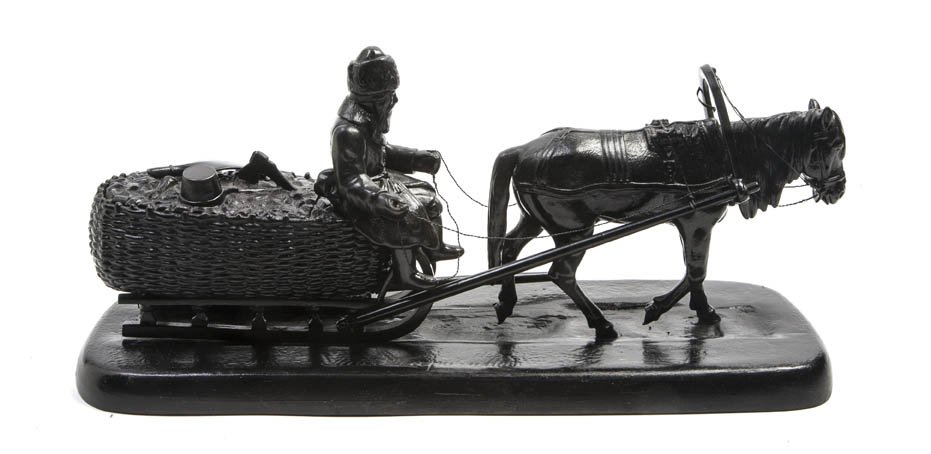 A Russian Bronzed Metal Figural Group, Width 14 in: A Russian Bronzed Metal Figural Group, depicting a peasant leading a horse drawn sleigh, carrying a load of wood, raised on a naturalistic rectangular base with rounded corners, signed indistinctly. W