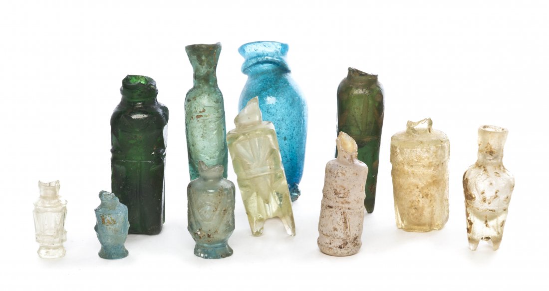 A Collection of Eleven Glass Bottles, Height of t: A Collection of Eleven Glass Bottles, 9th and 10th century, of fatimid blue, green and clear color. Height of tallest 2 3/4 inches.