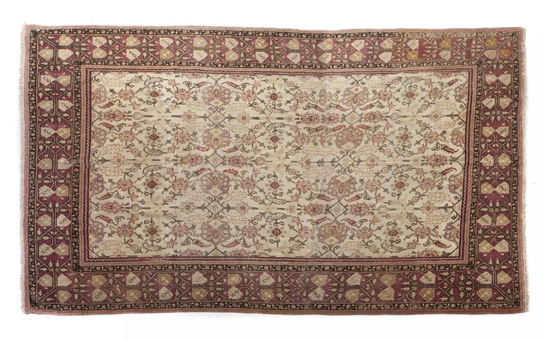 An Agra Wool Rug, 12 feet 1 inch x 8 feet 10 inch: An Agra Wool Rug, late 19th century, having allover stylized foliate decoration on an ivory field within multiple borders. 12 feet 1 inch x 8 feet 10 inches.