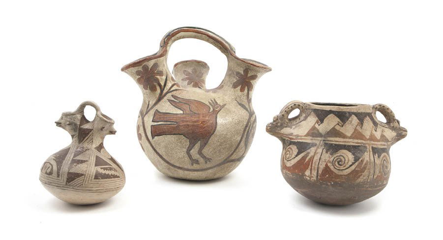 A Group of Three Native American Earthenware Vess: A Group of Three Native American Earthenware Vessels, comprising a handled triple spout vase, a vessel with stylized animal form handles and a smaller example. Height of tallest 10 inches.