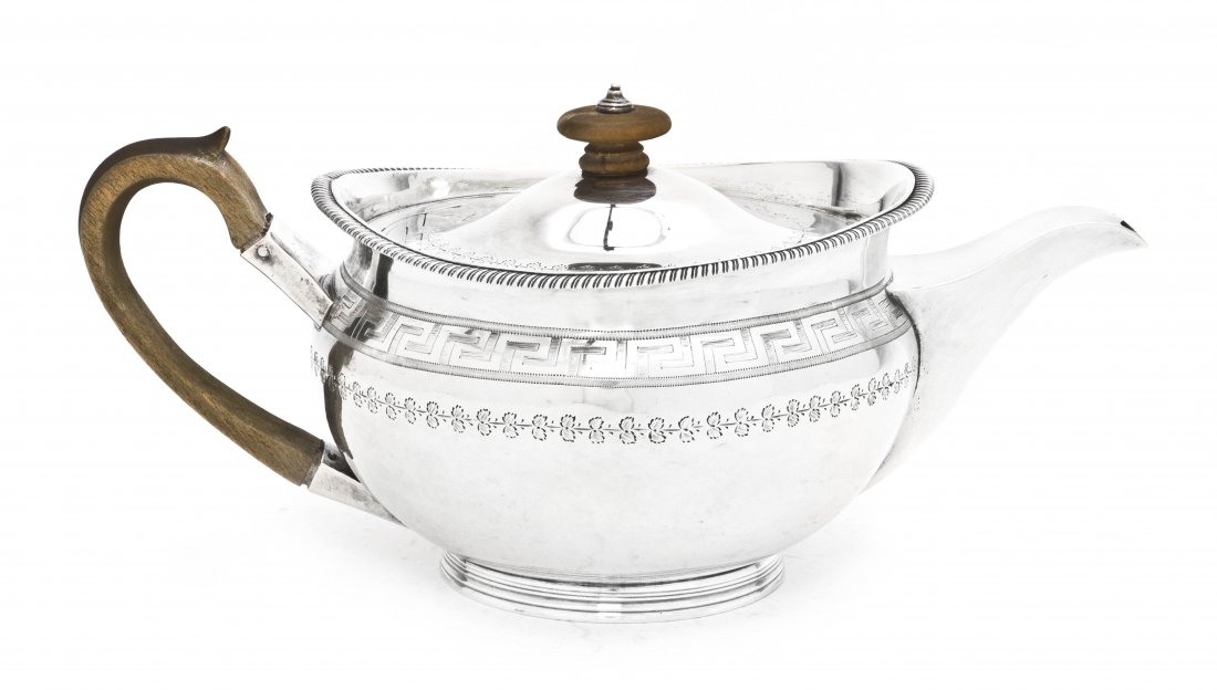 An English Silver Teapot, Robert Hennell I & Samu: An English Silver Teapot, Robert Hennell I & Samuel Hennell, London, 1805, of squat form with Greek key and foliate incised decoration, having wood finial and handle; approximate total weight overall 