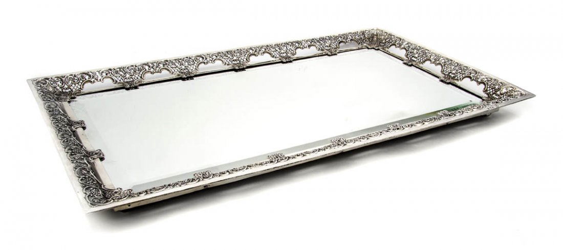 An English Silver Plateau Mirror, William Comyns: An English Silver Plateau Mirror, William Comyns & Sons, London, 1893, of rectangular form having a flared rim with pierced Rococo decoration centered by a conforming beveled plate. Width 23 1/2 inche