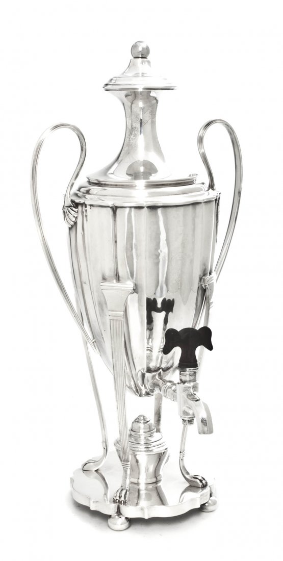 An English Silver Coffee Urn, I. S. Greenberg & C: An English Silver Coffee Urn, I. S. Greenberg & Co., Birmingham, 1905, having applied handles and a spigot with a wood handle, raised on four supports ending in paw feet upon a shaped circular base, m