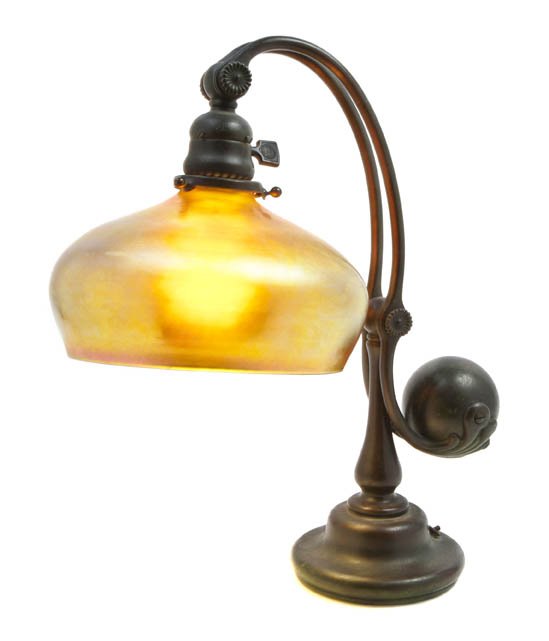 A Tiffany Studios Bronze Counter-Balance Desk Lam: A Tiffany Studios Bronze Counter-Balance Desk Lamp Base, the base impressed Tiffany Studios New York 417, set with a Steuben Aurene glass shade having gold iridescence. Height 15 1/2 inches x diameter