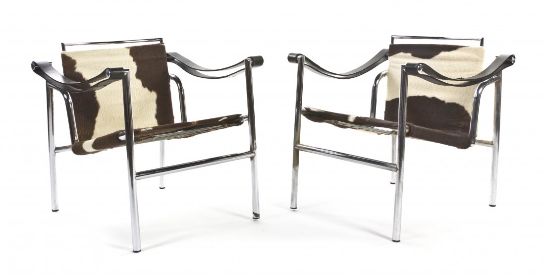 A Pair of Basculant Armchairs, attributed to Le C: A Pair of Basculant Armchairs, attributed to Le Corbusier, each having leather sling arms and a hide back and seat within a chromed tubular frame. Height 25 inches.