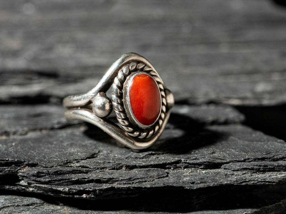 Lewis Lomay (Hopi, 1915-1996) Silver and Coral Ring: Lewis Lomay (Hopi, 1915-1996) Silver and Coral Ring spit shank with twisted wire bezel; marked LL with artist's snake hallmark size 6.25, weight 6.0 dwt. This lot is located in Cincinnati. Purchased J