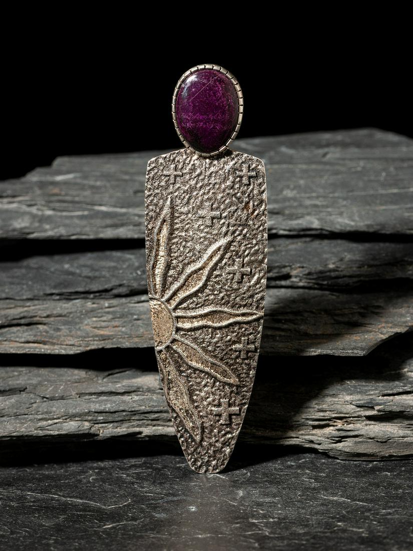 Darryl Dean Begay (Diné, b. 1973) Sugilite and Sterling Silver Tufa Cast Figural Pendant: Darryl Dean Begay (Diné, b. 1973) Sugilite and Sterling Silver Tufa Cast Figural Pendant marked DDB .925 length 4-3/8 inches x width 1-1/4 inches, weight 26.7 dwt. This lot is located in Cincinna