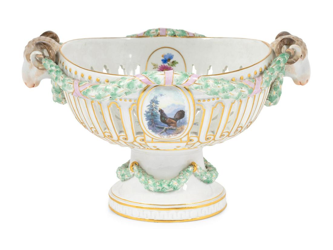 A Meissen Porcelain Centerpiece Basket: A Meissen Porcelain Centerpiece Basket 20th Century bearing crossed swords in underglaze blue, impressed F 46 102 and further marked 48 to the underside. Height 7 x width over handles 12 inches. This 