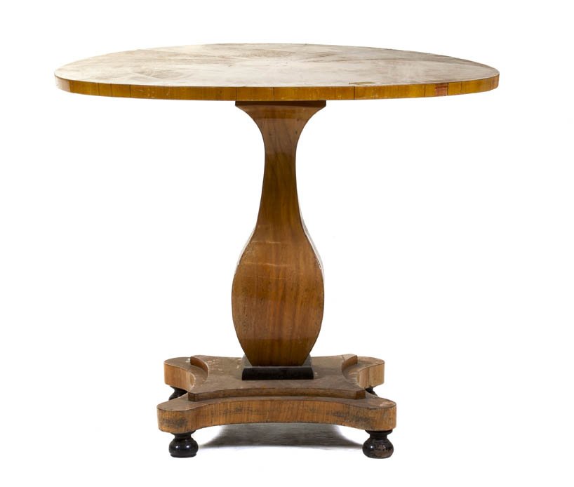 A Biedermeier Style Birch and Ebonized Center Tab: A Biedermeier Style Birch and Ebonized Center Table, having a circular top over the square baluster form standard, raised on ebonized flattened ball feet. Height 31 x diameter 36 inches. Property from