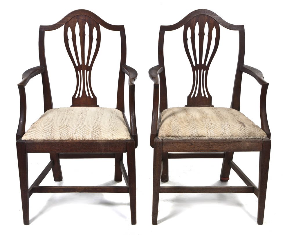 A Pair of Sheraton Style Mahogany Open Armchairs,: A Pair of Sheraton Style Mahogany Open Armchairs, having a pierce carved vertical splat over the upholstered seat, raised on tapering front legs joined by stretchers. Height 38 1/2 inches. Property fr