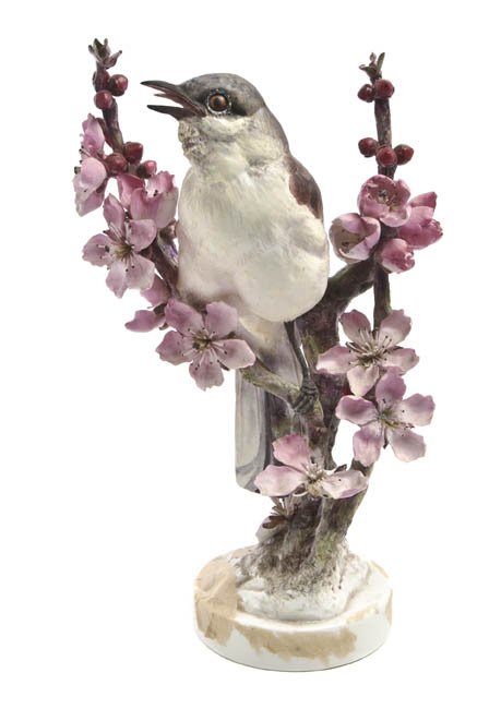 A Royal Worcester Dorothy Doughty Bird, Mocking B: A Royal Worcester Dorothy Doughty Bird, Mocking Bird, perched on peach blossom branches. Height 10 1/2 inches.
