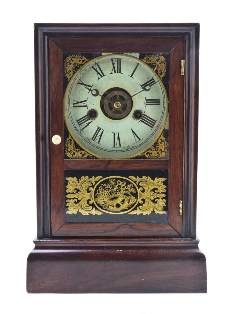 An American Shelf Clock, Atkins Clock Co., Height: An American Shelf Clock, Atkins Clock Co., having a circular dial with Roman numerals over an eglomise panel, with 30 day movement. Height 13 1/2 inches. Property from the Estate of Helen Mouzakeotis,