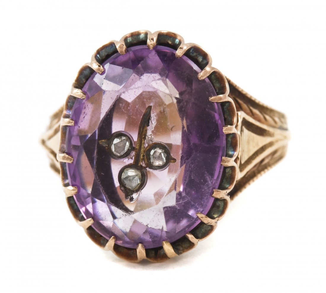 A Victorian Rose Gold, Amethyst and Diamond Ring, 5: A Victorian Rose Gold, Amethyst and Diamond Ring, containing one oval brilliant cut amethyst weighing approximately 10.00 carats with three rose cut diamonds and a gold accent inlaid into the table, w