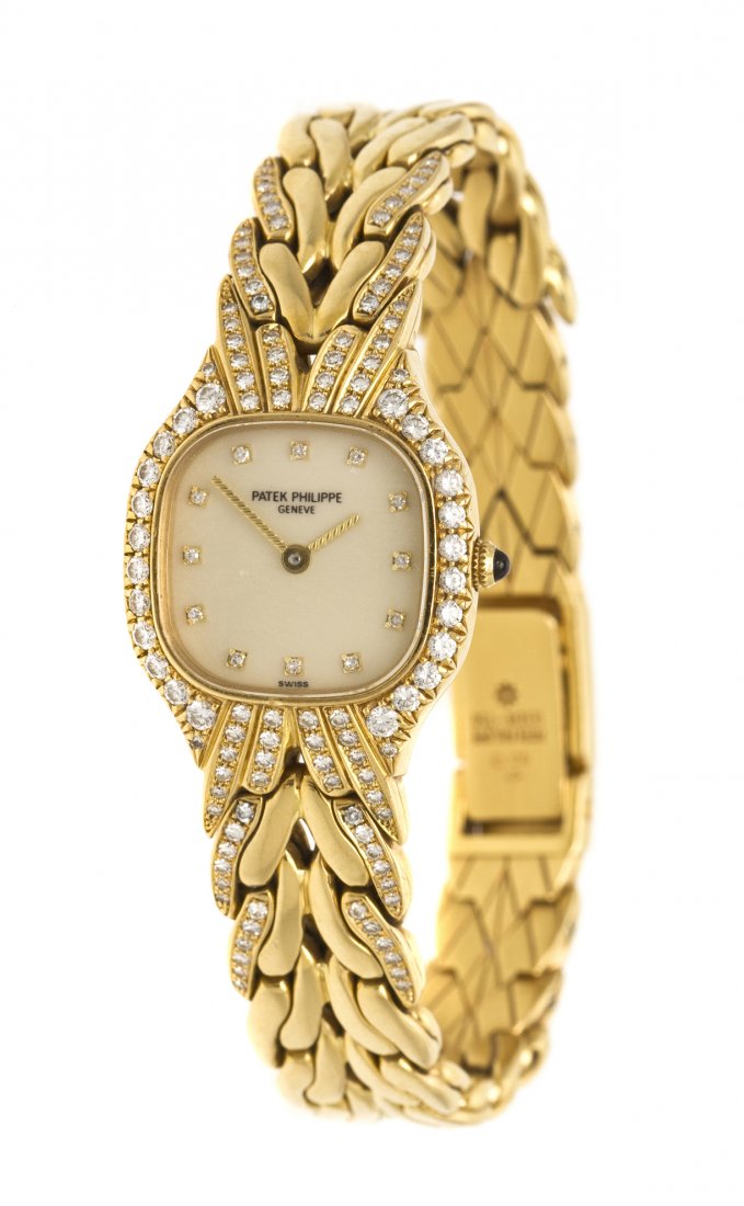 An 18 Karat Yellow Gold and Diamond Ref. 4815/3 Wr: An 18 Karat Yellow Gold and Diamond Ref. 4815/3 Wristwatch, Patek Philippe, 21.50 x 24.50 mm case dimensions, champagne dial, round single cut diamond numerals, yellow gold textured baton hands, bezel