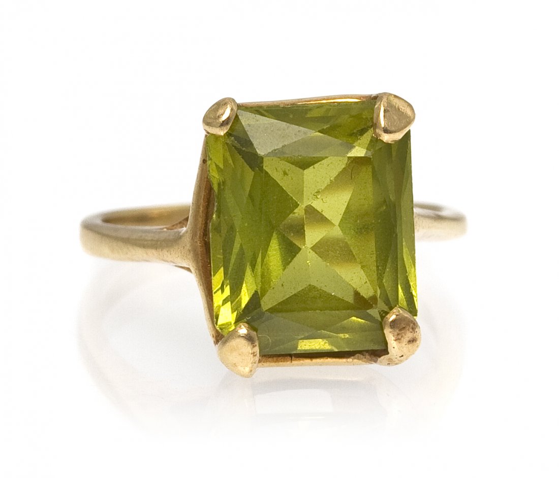 A 14 Karat Yellow Gold Peridot Ring, 2.95 dwts.: A 14 Karat Yellow Gold Peridot Ring, containing one octagonal mixed cut peridot weighing approximately 5.25 carats total. Stamped: 14K. 2.95 dwts. Property from the Estate of Mildred Heath Paxton, Kan