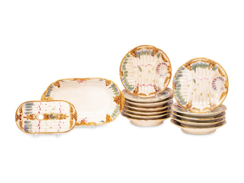A Polychrome-Glazed Earthenware Asparagus Service: A Polychrome-Glazed Earthenware Asparagus Service Attributed to Onnaing Faiencerie, France, Late 19th Century comprising of twelve plates, one oval serving dish and one trivet, the plates impressed G