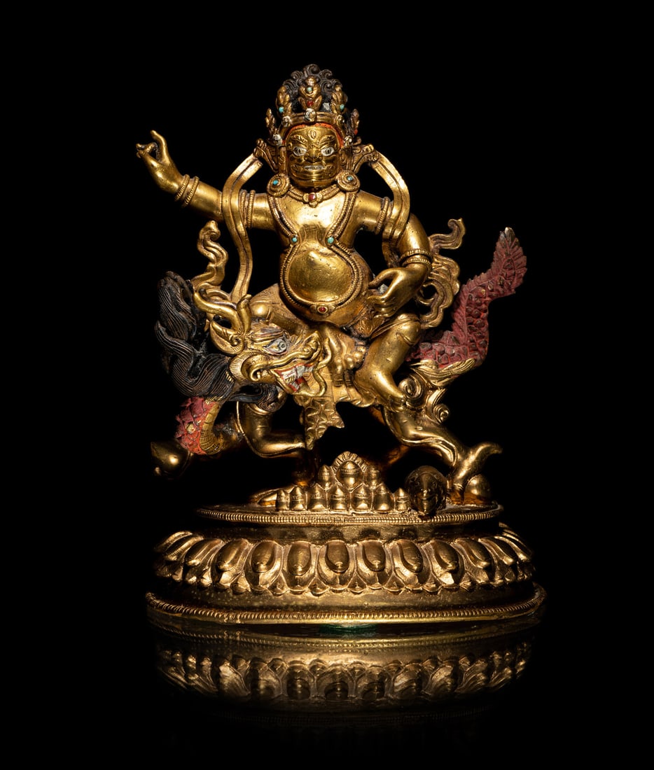A Sino-Tibetan Gilt Bronze Figure of Kubera: A Sino-Tibetan Gilt Bronze Figure of Kubera 18th-19th Century 清中期 銅鎏金財神像 seated in lalitasana over his lion with both hands in vitarka mu