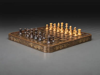 A Chinese Export Gilt Decorated Black Lacquer Folding Game Board: A Chinese Export Gilt Decorated Black Lacquer Folding Game Board 19th Century with 30 chess pieces. Height 3 x width 16 1/2 x depth 8 1/2 inches (closed). This lot is located in Cincinnati. Property f