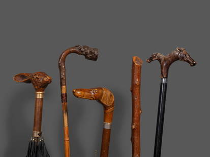 Four Walking Sticks: Four Walking Sticks Late 19th/20th Century including two examples with zoomorphic handles. together with an umbrella with rabbit-form handle. Length of longest 37 inches. This lot is located in Cincin