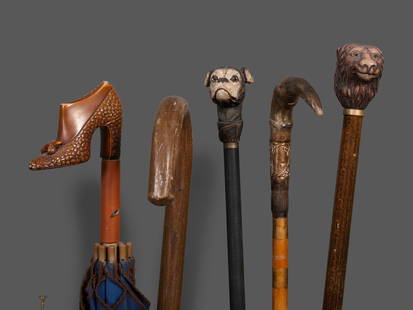 Four Walking Sticks: Four Walking Sticks Late 19th/20th Century including two examples with zoomorphic handles. together with an umbrella with shoe-form handle. Length of longest 36 3/4 inches. This lot is located in Cinc