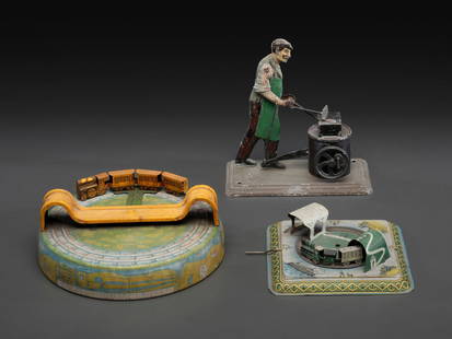 Three Tin Lithograph Windup Toys: Three Tin Lithograph Windup Toys Late 19th/Early 20th Century comprising a Bing blacksmith steam toy, a Marx 'Honeymoon Express' train toy, and a German train toy. each marked. Height of blacksmith 6