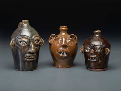 Three Southern Stoneware Face Jugs: Three Southern Stoneware Face Jugs 20th Century comprising examples by M.L. Owens, Seagrove, North Carolina, dated 1990, Matthew Hewell, Gillsville, Georgia, and a James Buchanan jug by Grace Nell Hew