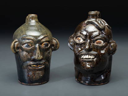 Two Southern Stoneware Face Jugs: Two Southern Stoneware Face Jugs 20th Century comprising an example by Chester Hewell and one by Grace Nell Hewell, Gillsville, Georgia. Height of larger 11 1/8 inches. This lot is located in Cincinna