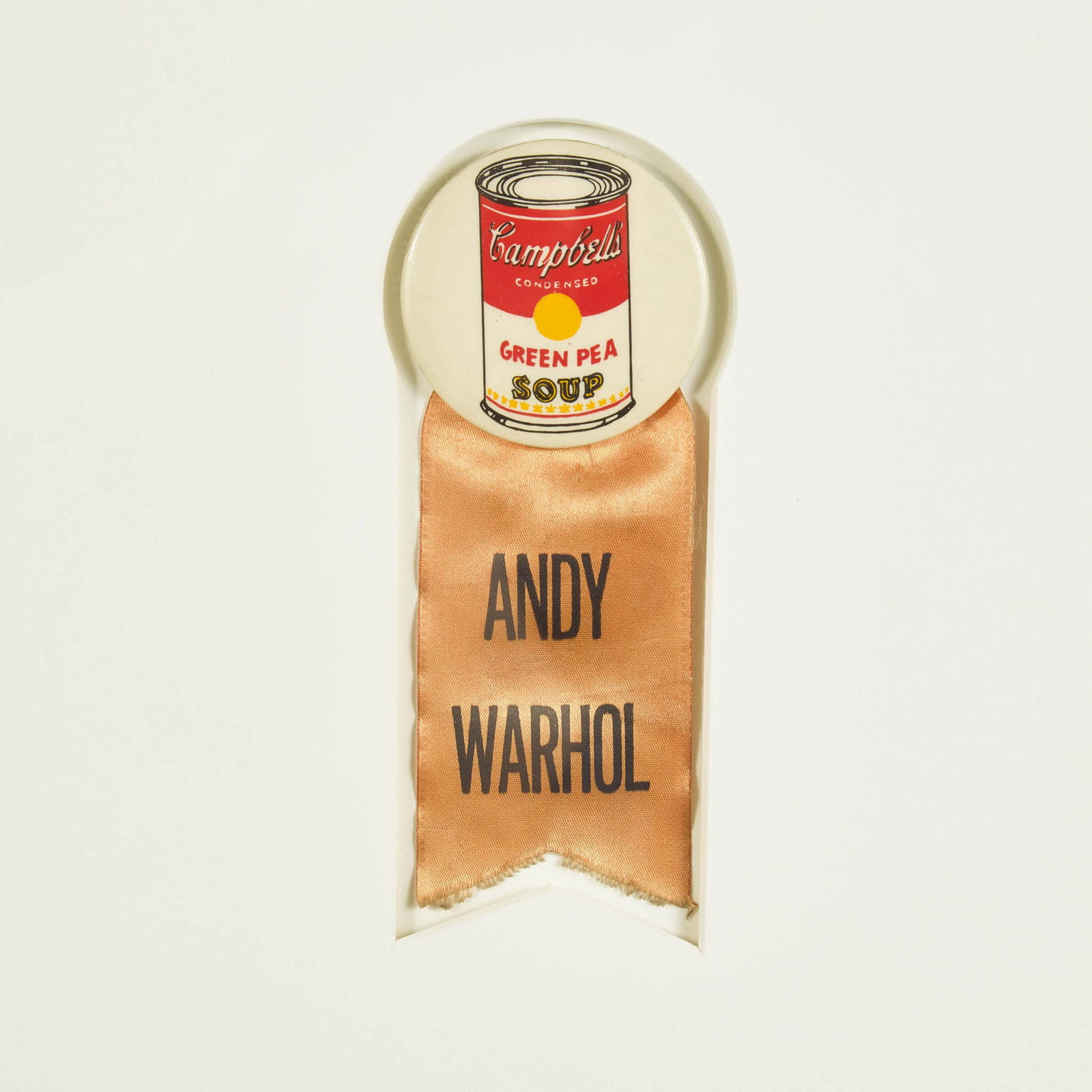 [Art] Warhol, Andy Campbell's Green Pea Soup Can Button: Warhol, Andy Campbell's Green Pea Soup Can Button (New York, 1962). 2 1/8 in. (54 mm) diameter pin-back button, printed in color with Campbell's' Green Pea Soup can; attached orange silk ribbon, print