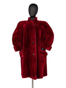 Bisang Sheared Beaver Coat, 1980s: Bisang Sheared Beaver Coat, 1980s Red-dyed sheared beaver fur coat with wide, cuffed sleeves, button-front closure, and a short, stand collar. Jacket features full lining and two hip pockets. 