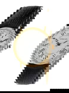 TIFFANY & CO., 14K YELLOW GOLD WATCH: TIFFANY & CO., 14K YELLOW GOLD WATCH Maker: Tiffany & Co. Case size: Approx. 30 mm Case material: 14K yellow gold Dial: White Movement: Quartz Bracelet/Strap: Black leather and buckle signed Tiffany &