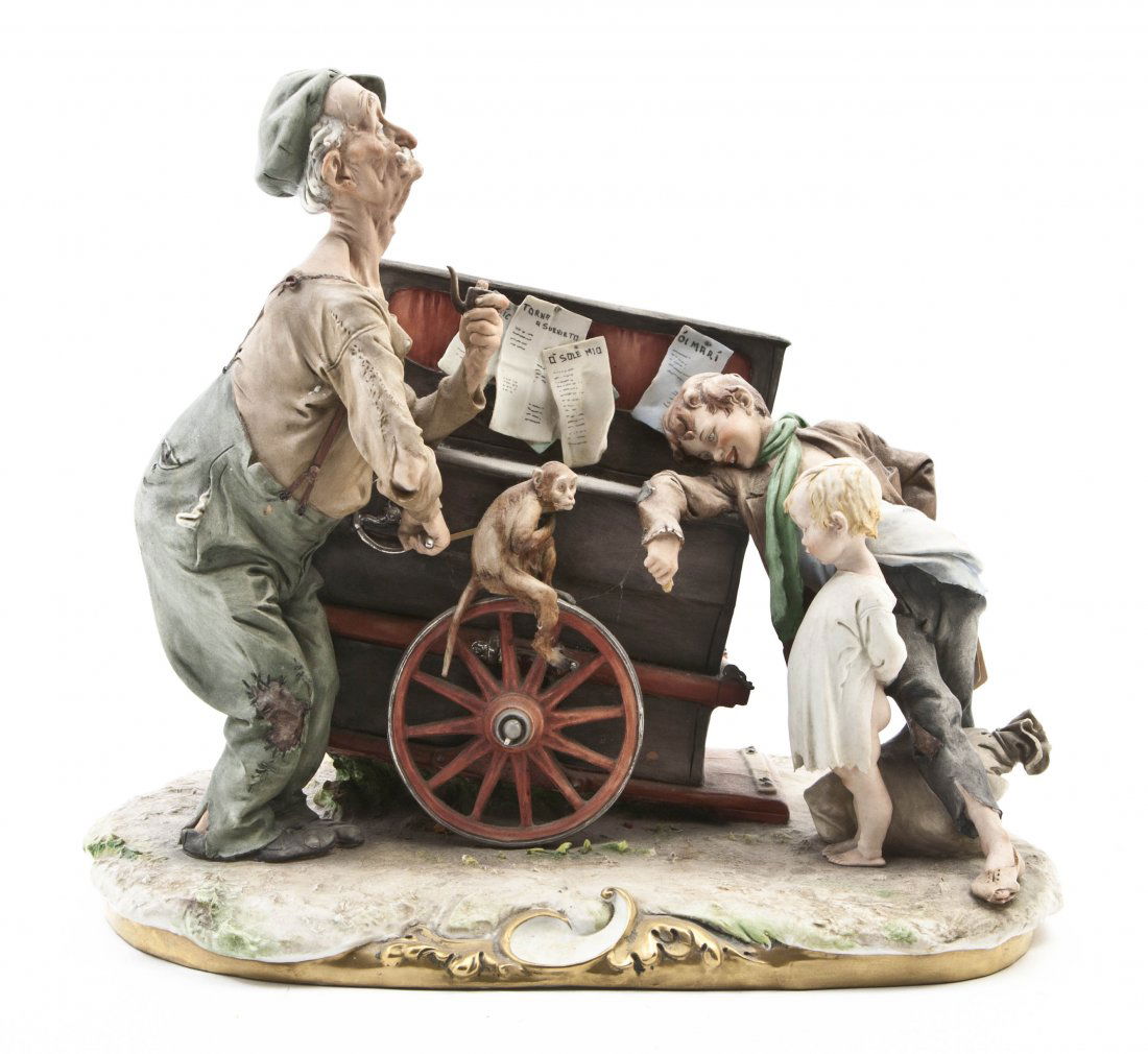 A Capodimonte Porcelain Figural Group, Width over: A Capodimonte Porcelain Figural Group, depicting two young boys watching an organ grinder. Width overall 14 1/4 inches. Property from the Lucie Sable Sandler Trust, Lincolnwood, Illinois
