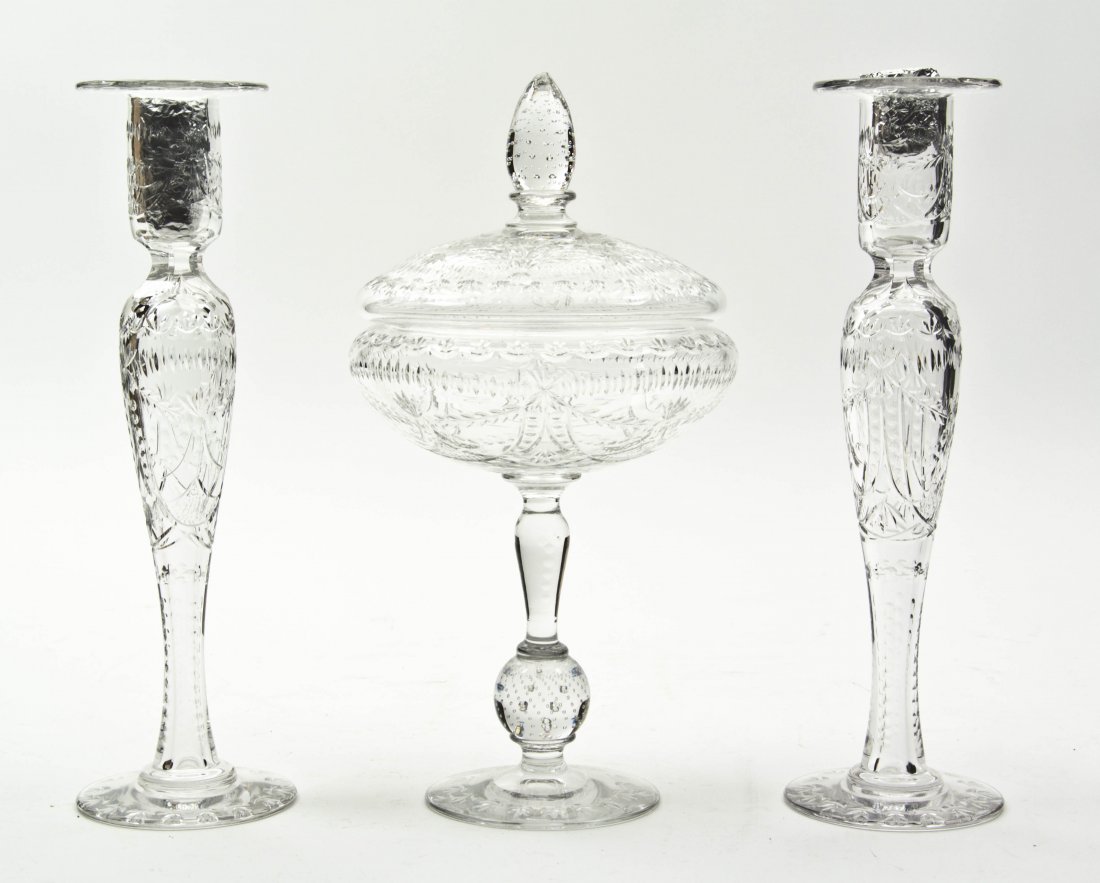 An Assembled Cut Glass Garniture, Height 12 inche: An Assembled Cut Glass Garniture, each with etched decoration throughout, comprising a covered center bowl raised on a conforming base, and two candlesticks. Height 12 inches. Property from the Estate