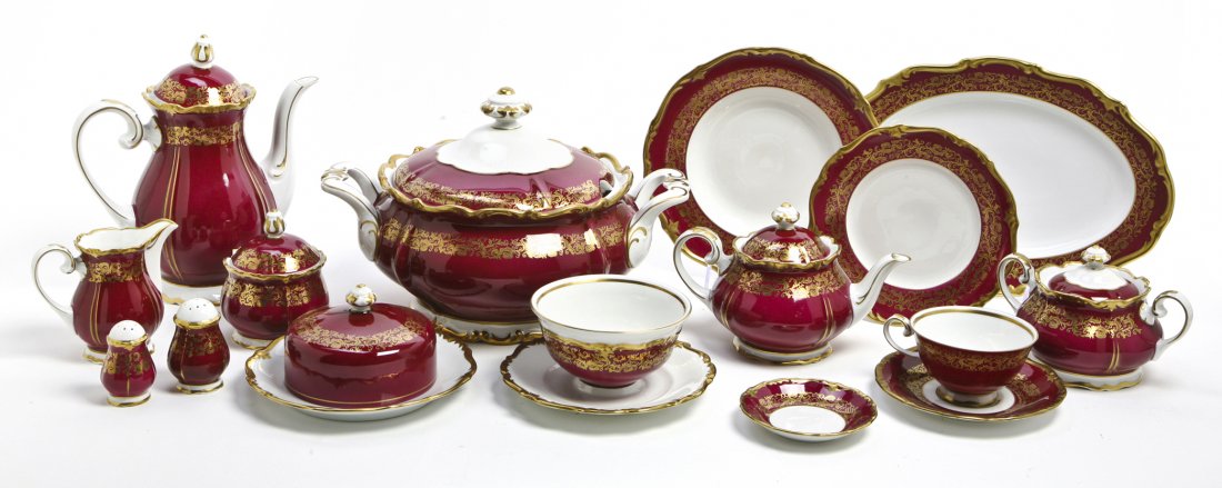 A German Porcelain Dinner Service, Diameter of di: A German Porcelain Dinner Service, comprising a tureen, 11 dinner plates, 6 saucers, 12 salad plates, a covered butter, 2 covered sugars, 2 oval platters and others; 60 items total. Diameter of dinner