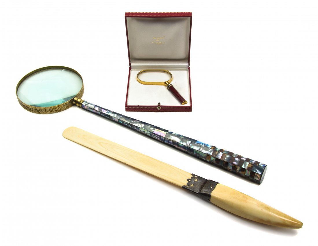 A Group of Three Desk Articles, Length of longest: A Group of Three Desk Articles, comprising a walrus ivory page turner with an English silver mount by John Armstrong, London, 1897, a magnifying glass with a mother-of-pearl veneered handle and a Les