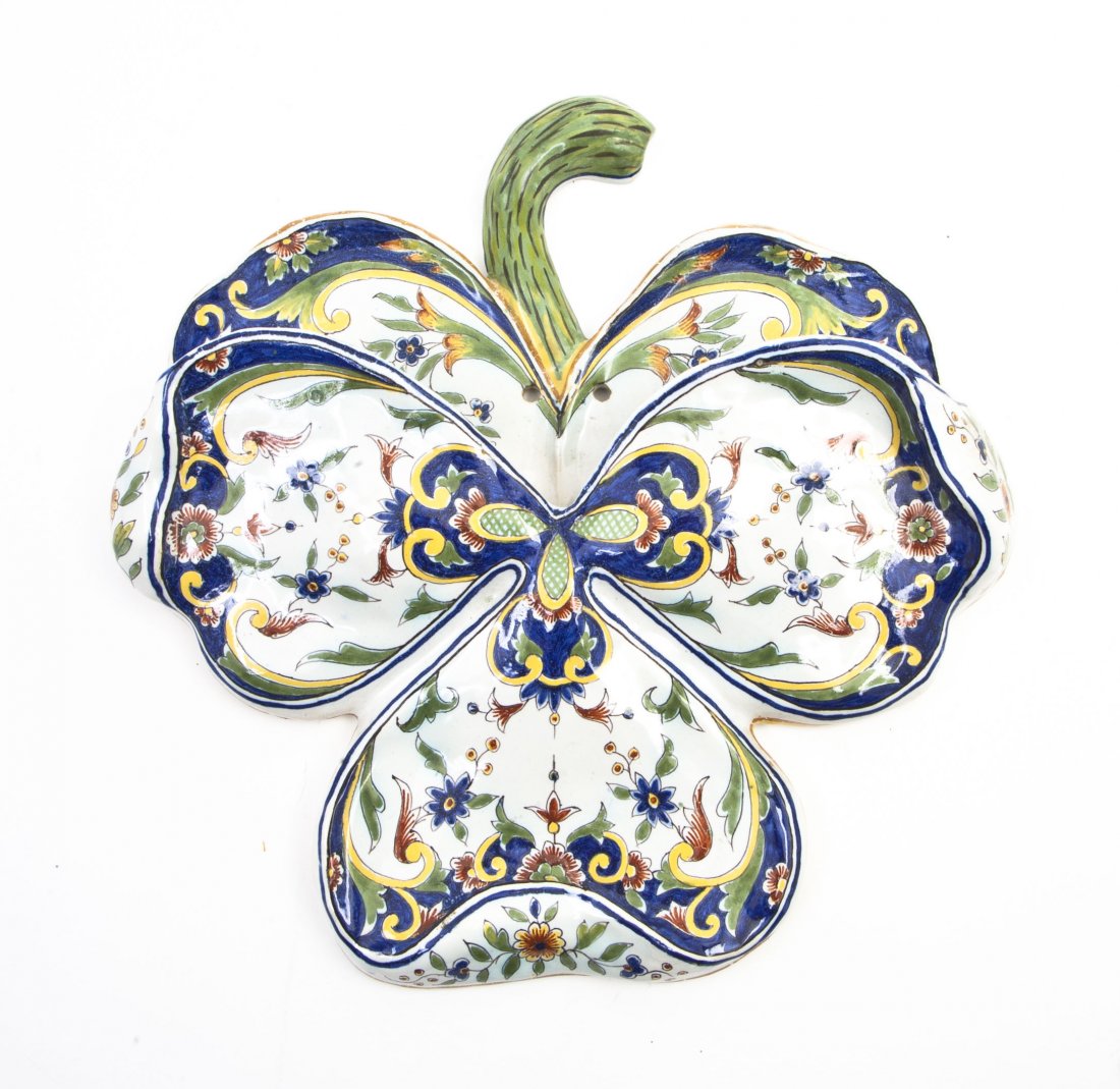 A French Faience Wall Pocket, Height 12 x width 1: A French Faience Wall Pocket, in the form of a three leaf clover, having polychrome floral decoration throughout. Height 12 x width 12 inches.