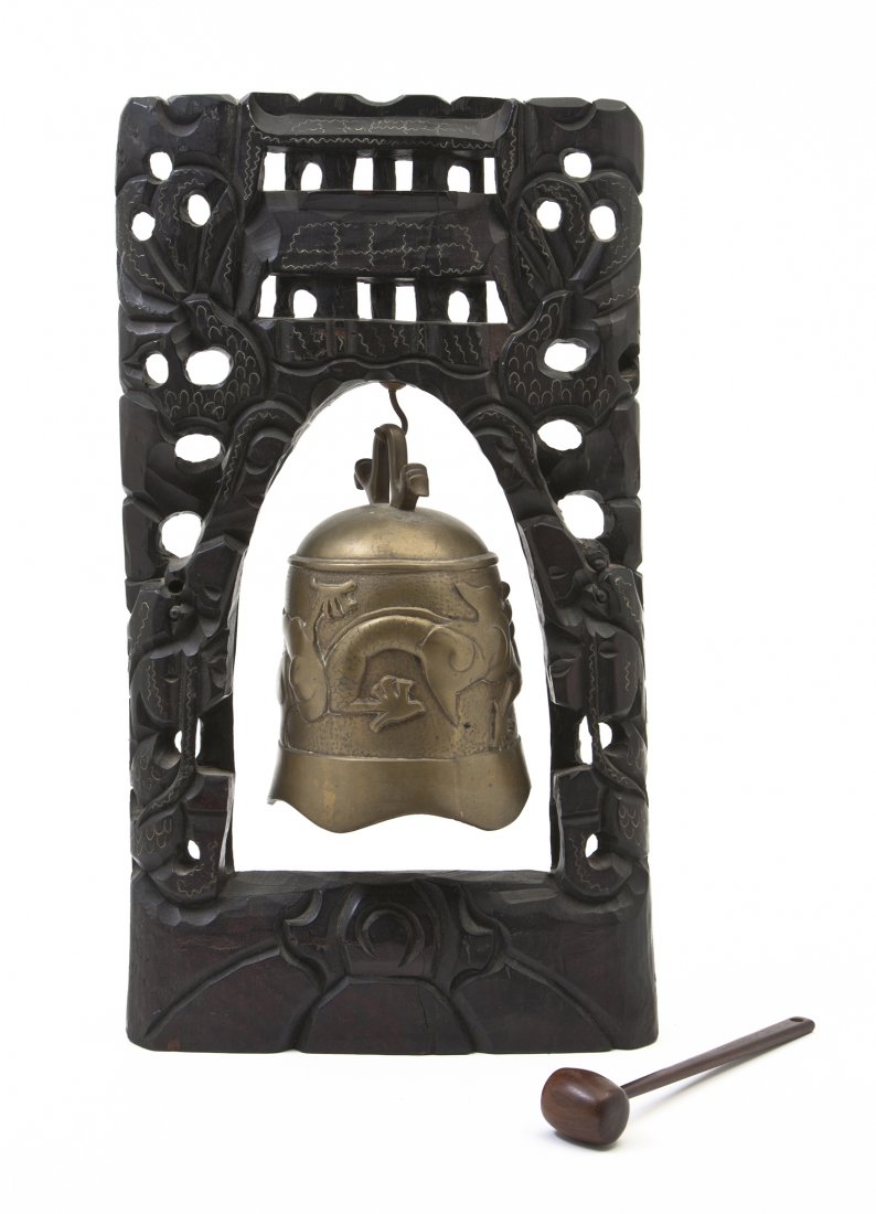 A Chinese Bronze Bell, Height overall 17 3/8 inch: A Chinese Bronze Bell, having raised decoration of a writhing dragon chasing a flaming pearl, suspended within an ebonized pierce carved wood frame with a hardwood mallet. Height overall 17 3/8 inches