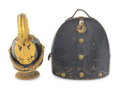 An Austrian Black Lacquer and Gilt Metal WWI Dragoon Helmet Model 1905: An Austrian Black Lacquer and Gilt Metal WWI Dragoon Helmet Model 1905 20th Century on a stand and with a fitted case. Height of helmet 12 1/2 x width 11 inches. This lot is located in Chicago. Proper