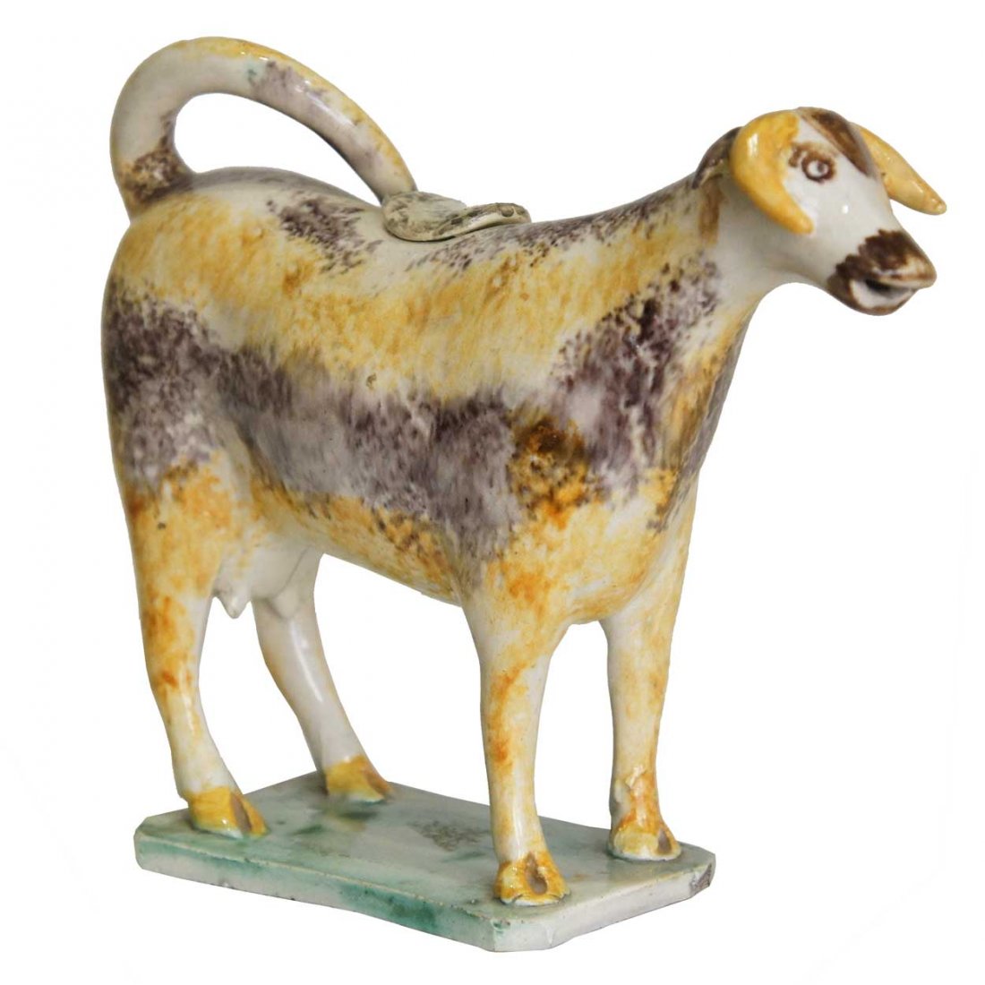 An English Staffordshire Pearlware Cow Creamer, He: An English Staffordshire Pearlware Cow Creamer, circa 1810, early figure of a standing cow on a rectangular, canted corner base, decorated with puce and yellow sponge decoration; the upturned tail for