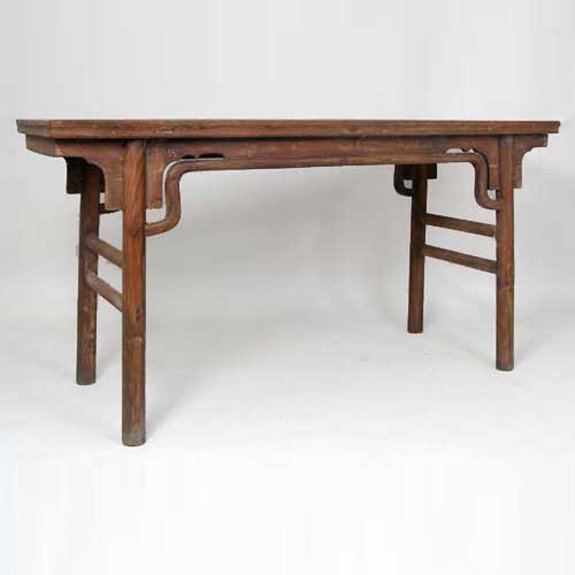 A Chinese Ming Style Elm Recessed Trestle-Leg Alta: A Chinese Ming Style Elm Recessed Trestle-Leg Altar Table, circa 1790, having a floating panel rectangular top; the edge of the apron forming the front spandrels, which surmount in a rounded, front s
