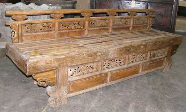 A Chinese Shanxi Elm Temple Bench, Height 30 x wid: A Chinese Shanxi Elm Temple Bench, circa 1760, the back having an upper rail supported by lotus flower struts, and surmounting lower panels, hand carved and pierced with floral designs; the apron bene