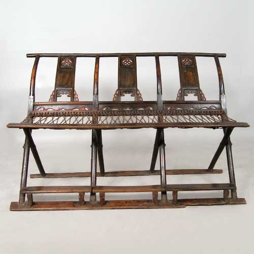 A Chinese Elm Folding Three-Seat Bench, Height 38: A Chinese Elm Folding Three-Seat Bench, circa 1760, having pole and board construction, with three back splats, each with pomegranate piercing and small, cloud-form spandrels. Height 38 x width 58 x d