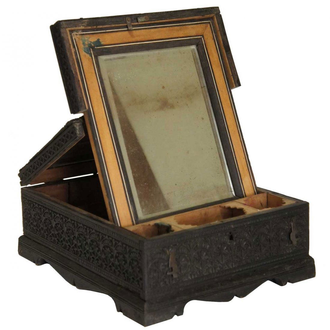 An Indian Nagina Ebony and Sandalwood Traveling Dr: An Indian Nagina Ebony and Sandalwood Traveling Dresser Box, circa 1850, of rectangular form, carved overall in low relief with floral, arcades and geometric patterns and raised on bracket feet with a