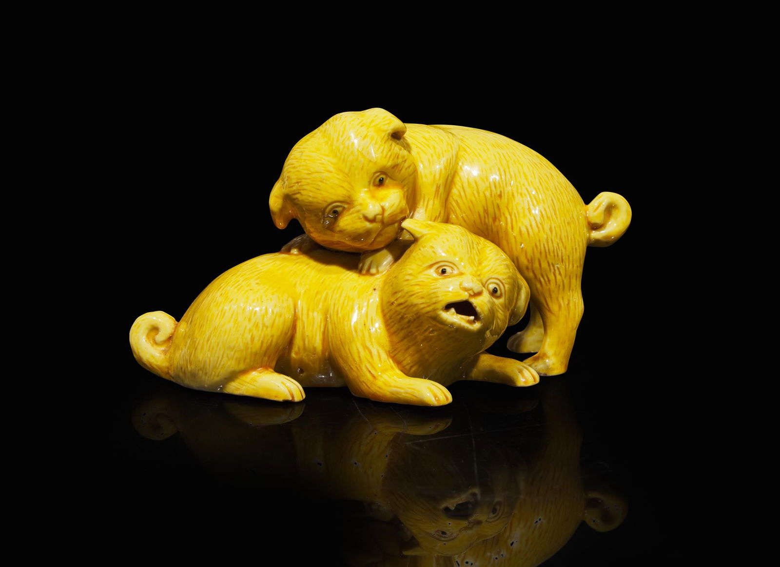 A Japanese yellow-glazed porcelain "Puppies Playing" group, possibly Hirado, 19th/early 20th century (1 of 3)