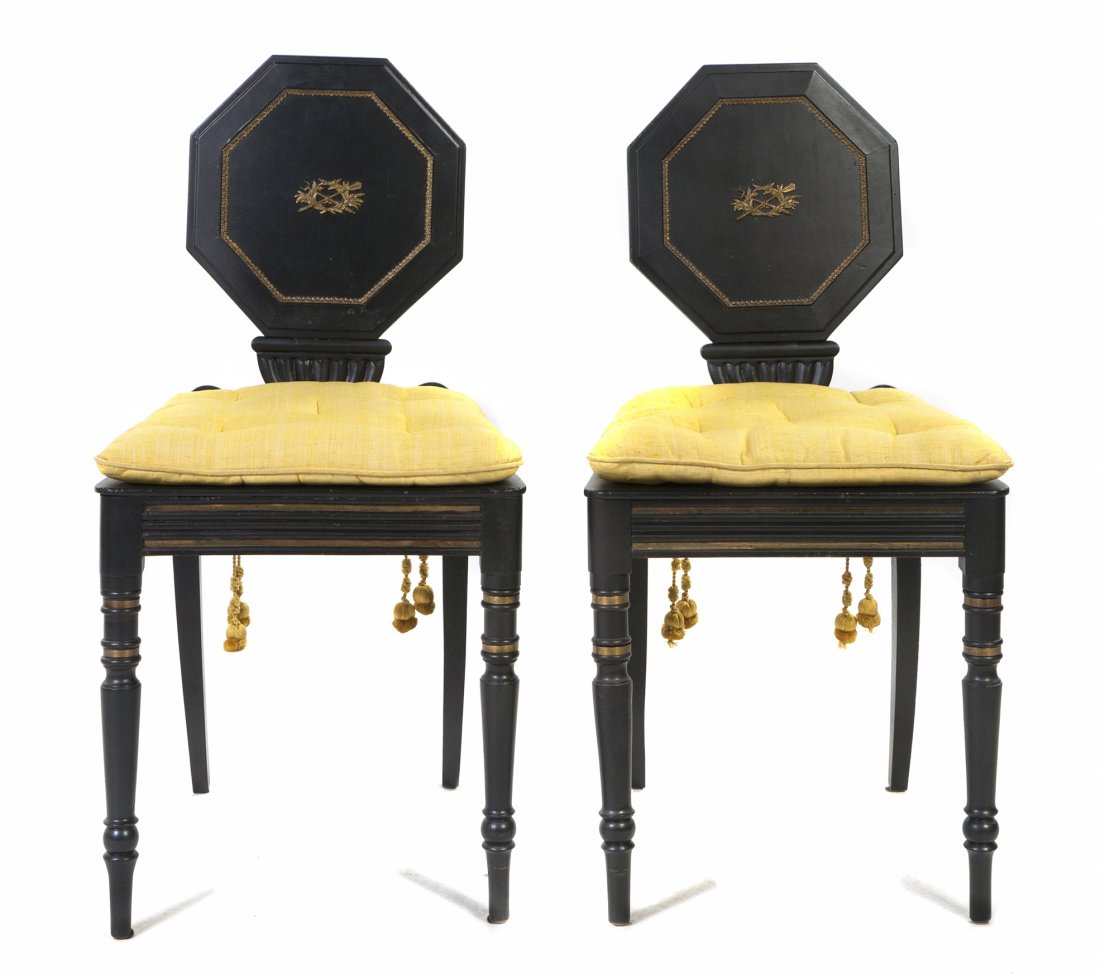A Pair of English Ebonized and Parcel Gilt Hall Cha: A Pair of English Ebonized and Parcel Gilt Hall Chairs, each with an octagonal back and trapezoidal seat, raised on turned legs. Height 35 inches.