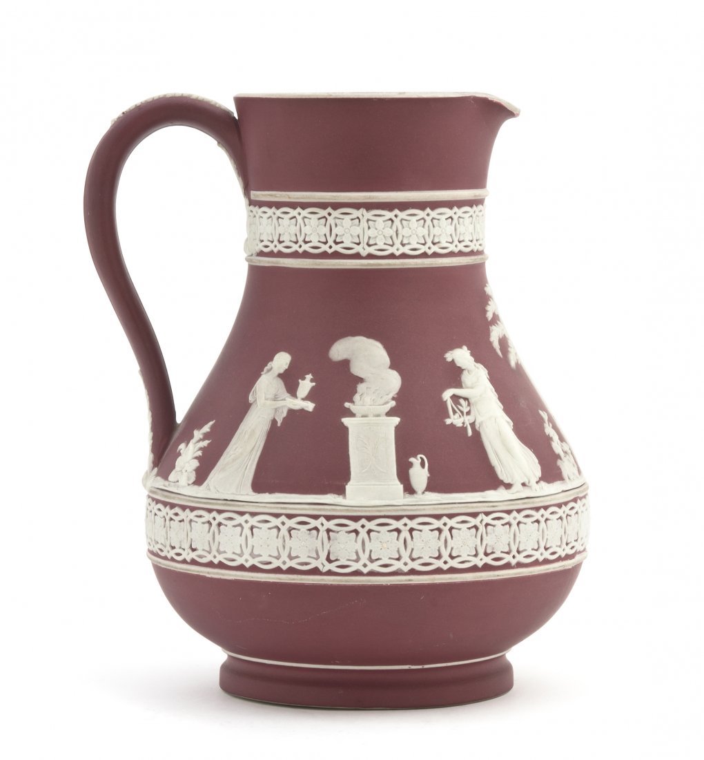 A Wedgwood Crimson Jasperware Etruscan Pitcher, He: A Wedgwood Crimson Jasperware Etruscan Pitcher, circa 1920, of baluster form having classical figures within bands of repeating foliate decoration, impressed Wedgwood England with other various impres