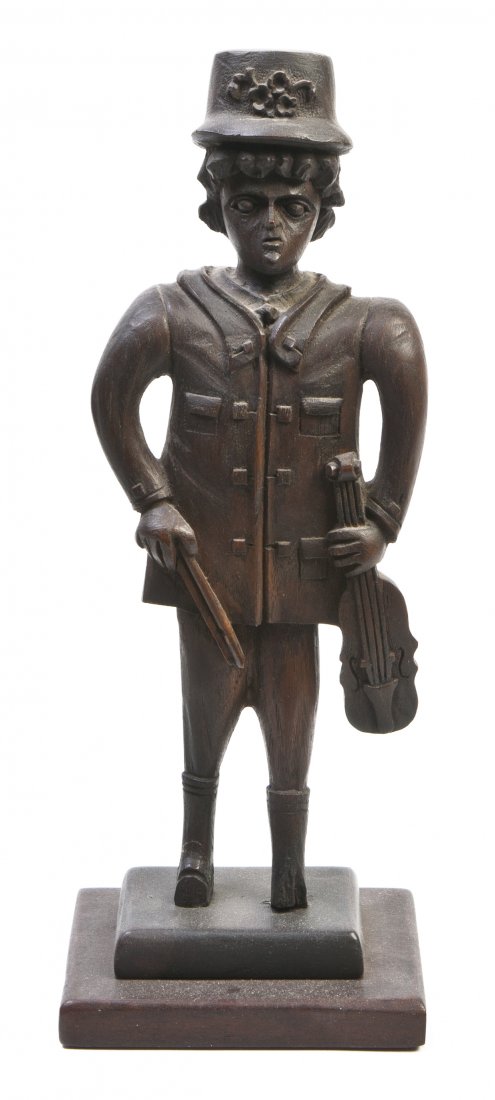 A Folk Art Carved Wood Figure, Height overall 15 1: A Folk Art Carved Wood Figure, depicting a standing male holding a violin, raised on a rectangular base. Height overall 15 1/4 inches. Property from the Collection of A. Phillip Trier, Wilmette, Illin
