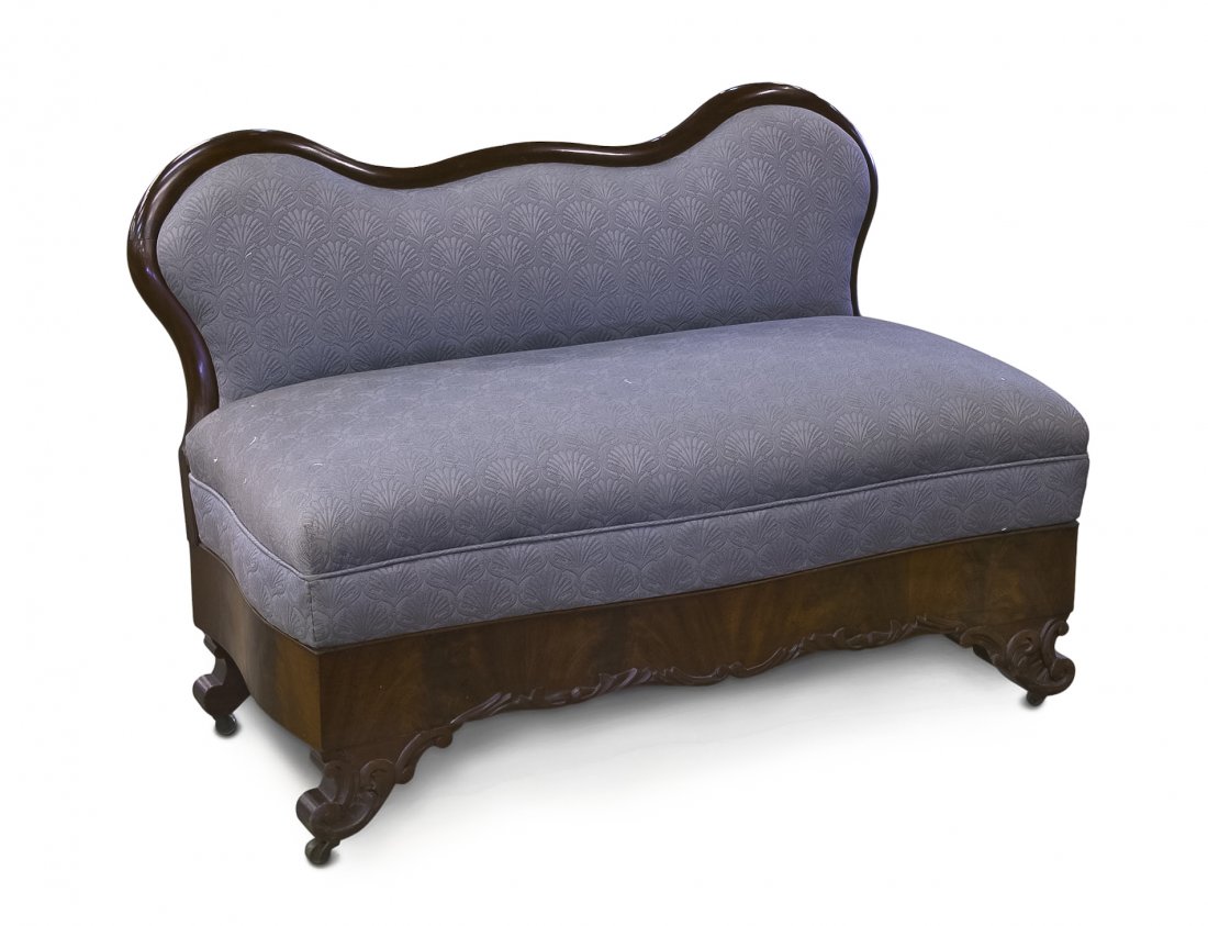 An American Empire Mahogany Window Bench, Height 3: An American Empire Mahogany Window Bench, having a serpentine crest rail over the upholstered back and seat, raised on scrolling feet ending in casters. Height 30 x width 42 3/4 x depth 23 inches. Pro