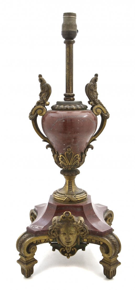 A Continental Rouge Marble and Ormolu Mounted Lamp: A Continental Rouge Marble and Ormolu Mounted Lamp, having a baluster form standard with mask and scrolled handles over the quadripartite base flanked with masks of Diana, raised on square fluted feet